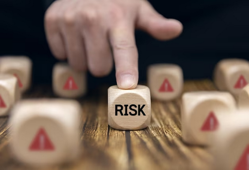 Wooden cubes with warning symbols and 'risk'