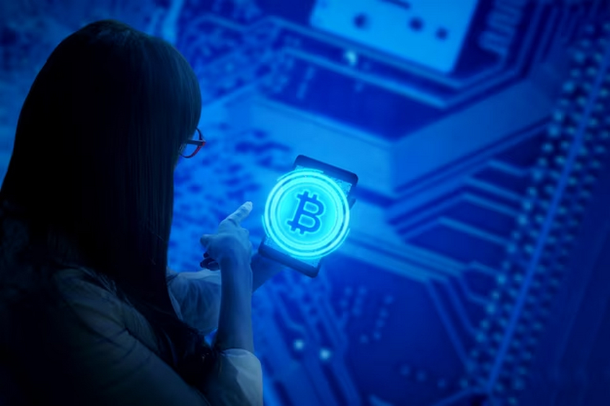 Woman holding a phone with Bitcoin displayed on the screen