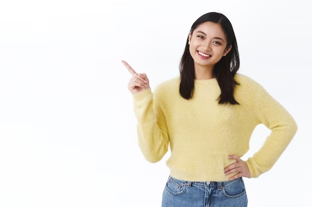 Woman in yellow long sleeves pointing to the side